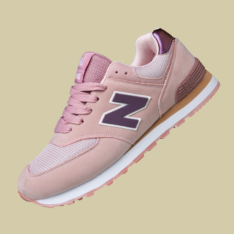 Pink sneaker with a brand logo on a white background